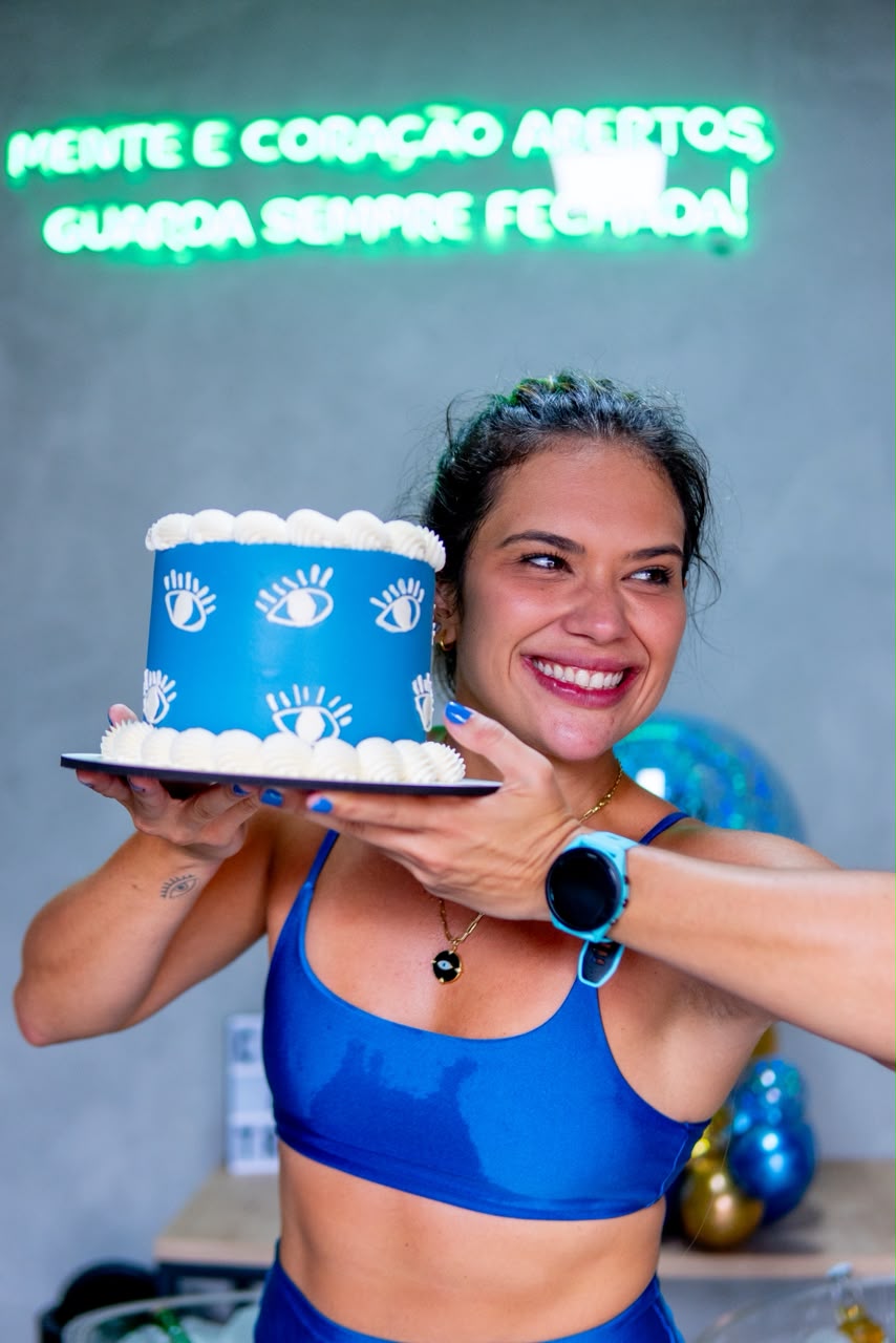 Aniversariante com bolo sob o neon mente e coração abertos